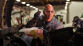 technician working on a truck engine